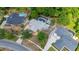 Expansive aerial view of a home showcasing a screened pool, lush landscaping, and beautiful neighborhood at 694 Tuscora Dr, Winter Springs, FL 32708
