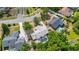 Lush trees surround this residence, captured in an aerial shot, highlighting its private screened pool at 694 Tuscora Dr, Winter Springs, FL 32708