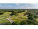 Scenic aerial of a meticulously maintained golf course, surrounded by lush landscaping, under a sunny sky at 694 Tuscora Dr, Winter Springs, FL 32708