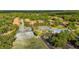 Aerial view of community featuring tennis courts, pool, and residences surrounded by mature landscaping at 694 Tuscora Dr, Winter Springs, FL 32708