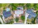 Aerial view of a home's roof surrounded by lush landscaping and neighboring properties, creating a private oasis at 694 Tuscora Dr, Winter Springs, FL 32708