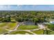 Expansive aerial perspective of community clubhouse overlooking a lush golf course and neighborhood at 694 Tuscora Dr, Winter Springs, FL 32708