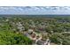 Scenic aerial view of a neighborhood featuring green trees, winding roads, and a centrally located home at 694 Tuscora Dr, Winter Springs, FL 32708