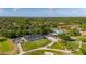 Scenic aerial view of a community clubhouse with golf course, pool, tennis courts, and natural surroundings at 694 Tuscora Dr, Winter Springs, FL 32708