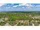 Wide aerial shot shows a home in a neighborhood with beautiful trees and lush landscapes, enhancing its serene appeal at 694 Tuscora Dr, Winter Springs, FL 32708
