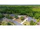 An aerial view of the neighborhood shows mature trees surrounding the homes at 694 Tuscora Dr, Winter Springs, FL 32708