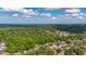 A stunning aerial showcases a home surrounded by lush greenery, offering a glimpse of neighborhood tranquility at 694 Tuscora Dr, Winter Springs, FL 32708