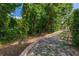 An expansive backyard is accented with a retaining wall and lush, mature trees at 694 Tuscora Dr, Winter Springs, FL 32708