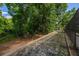 An expansive backyard is accented with a retaining wall and lush, mature trees at 694 Tuscora Dr, Winter Springs, FL 32708
