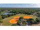 Aerial view of a baseball field surrounded by trees and a lake, showcasing the community's recreational amenities at 694 Tuscora Dr, Winter Springs, FL 32708