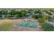 Aerial view of a community's four basketball courts with green surfaces and new white lines with green surrounding areas at 694 Tuscora Dr, Winter Springs, FL 32708