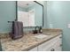 Bathroom vanity featuring granite countertops, white cabinetry, and black hardware at 694 Tuscora Dr, Winter Springs, FL 32708