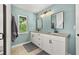 Beautiful bathroom with dual sinks, granite countertops, modern lighting, and a glass-enclosed shower at 694 Tuscora Dr, Winter Springs, FL 32708