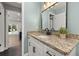 Bathroom vanity has granite countertops, white cabinetry, and black hardware at 694 Tuscora Dr, Winter Springs, FL 32708