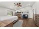 Spacious bedroom featuring wood floors, a ceiling fan, TV, seating, and sliding glass doors at 694 Tuscora Dr, Winter Springs, FL 32708