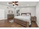 This bedroom features a wooden bed frame, wood floors, a ceiling fan, and a spacious walk-in closet at 694 Tuscora Dr, Winter Springs, FL 32708