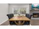 Dining area with rustic table next to a fireplace and sliding glass doors leading to an outdoor area at 694 Tuscora Dr, Winter Springs, FL 32708