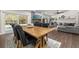 Dining room featuring a rustic table and chairs, with a view of the living room and sliding glass doors at 694 Tuscora Dr, Winter Springs, FL 32708