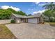 Charming home with brick accents, a two-car garage, and a beautifully paved driveway at 694 Tuscora Dr, Winter Springs, FL 32708