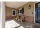 Inviting front porch with brick accents and two chairs for enjoying the outdoors at 694 Tuscora Dr, Winter Springs, FL 32708