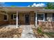 Inviting front porch with brick accents and two chairs for enjoying the outdoors at 694 Tuscora Dr, Winter Springs, FL 32708