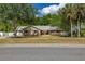 Charming single-story home featuring a well-manicured lawn and beautiful mature trees at 694 Tuscora Dr, Winter Springs, FL 32708