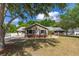 Charming single-story home featuring a well-manicured lawn and beautiful mature trees at 694 Tuscora Dr, Winter Springs, FL 32708