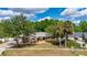 This charming single-Gathering home features a well-manicured lawn, mature trees, and driveway at 694 Tuscora Dr, Winter Springs, FL 32708