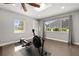 A well-lit home gym with ample natural light from the window and a ceiling fan at 694 Tuscora Dr, Winter Springs, FL 32708