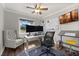 Well-lit home office with an ergonomic chair and large windows at 694 Tuscora Dr, Winter Springs, FL 32708