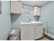 Laundry room with washer, dryer, laundry decor and storage at 694 Tuscora Dr, Winter Springs, FL 32708