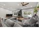 Spacious living room featuring hardwood floors, a cozy fireplace, and sliding doors to the pool at 694 Tuscora Dr, Winter Springs, FL 32708