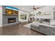 Spacious living room with modern gray brick fireplace and sliding glass doors for natural light at 694 Tuscora Dr, Winter Springs, FL 32708