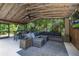 This screened patio is made for entertaining with its seating, dining space, and TV at 694 Tuscora Dr, Winter Springs, FL 32708
