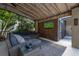 A screened patio includes a sectional and TV, perfect for relaxing with lush views and a beverage at 694 Tuscora Dr, Winter Springs, FL 32708