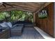 Relax on this screened patio featuring wood accents, ceiling fan, TV, and comfortable seating with outdoor rug at 694 Tuscora Dr, Winter Springs, FL 32708