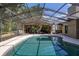 Enclosed pool area with an outdoor kitchen and lounge, perfect for relaxation and entertaining at 694 Tuscora Dr, Winter Springs, FL 32708