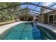 Backyard pool area featuring a screened enclosure and ample seating at 694 Tuscora Dr, Winter Springs, FL 32708