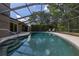 An in-ground pool is surrounded by a screened enclosure, offering a private backyard retreat at 694 Tuscora Dr, Winter Springs, FL 32708
