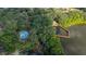 Aerial view of a walking trail through a wooded area with a lake and a small fountain at 694 Tuscora Dr, Winter Springs, FL 32708