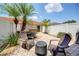 This backyard features a paver patio, outdoor seating, palm trees, and a privacy fence at 7348 Yoder St, Windermere, FL 34786