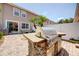 This backyard has a built in grill, outdoor seating, palm trees, and pavers at 7348 Yoder St, Windermere, FL 34786