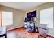 Bright bedroom with hardwood floors, desk, modern chair, and a mini fridge at 7348 Yoder St, Windermere, FL 34786