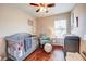 This Bedroom features a crib, a rocking chair, hardwood floors, and a changing table at 7348 Yoder St, Windermere, FL 34786