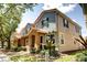 Exterior view of a well-maintained townhome with red tile roof, colorful siding, and landscaped surroundings at 7348 Yoder St, Windermere, FL 34786