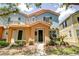 Charming townhome with a colorful exterior, manicured landscaping, and a welcoming front entrance at 7348 Yoder St, Windermere, FL 34786