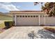This garage has a red tile roof, two doors, and landscaping at 7348 Yoder St, Windermere, FL 34786