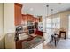 An open kitchen featuring granite countertops, stainless steel appliances, and wood cabinetry at 7348 Yoder St, Windermere, FL 34786