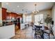 A well-lit kitchen featuring stainless steel appliances, wood cabinetry, and a dining area at 7348 Yoder St, Windermere, FL 34786