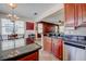 An open kitchen featuring granite countertops, stainless steel appliances, and tile flooring at 7348 Yoder St, Windermere, FL 34786